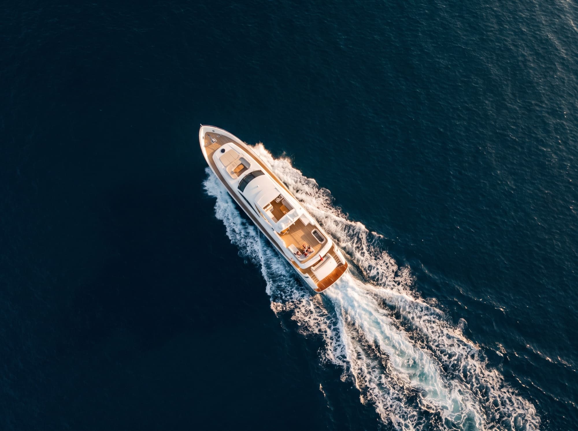 Aerial view of a yacht sailing on a deep blue sea